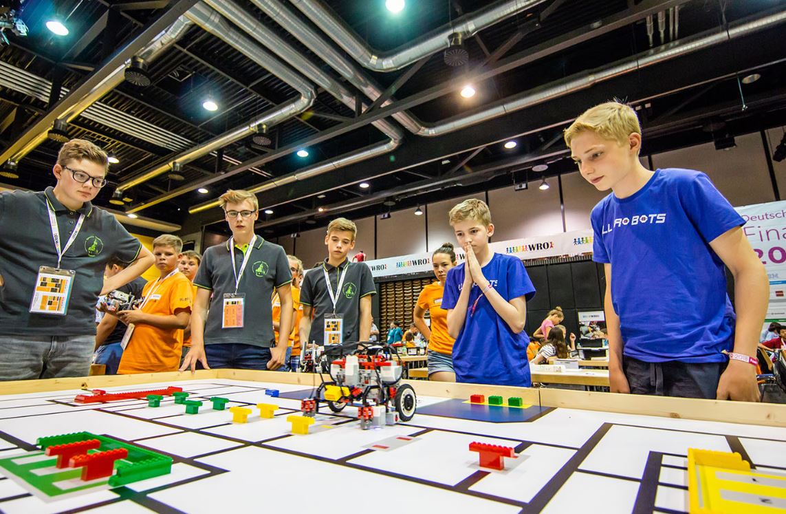 Students participating in World Robot Olympiad, developing their confidence to learn and understand complex concepts.